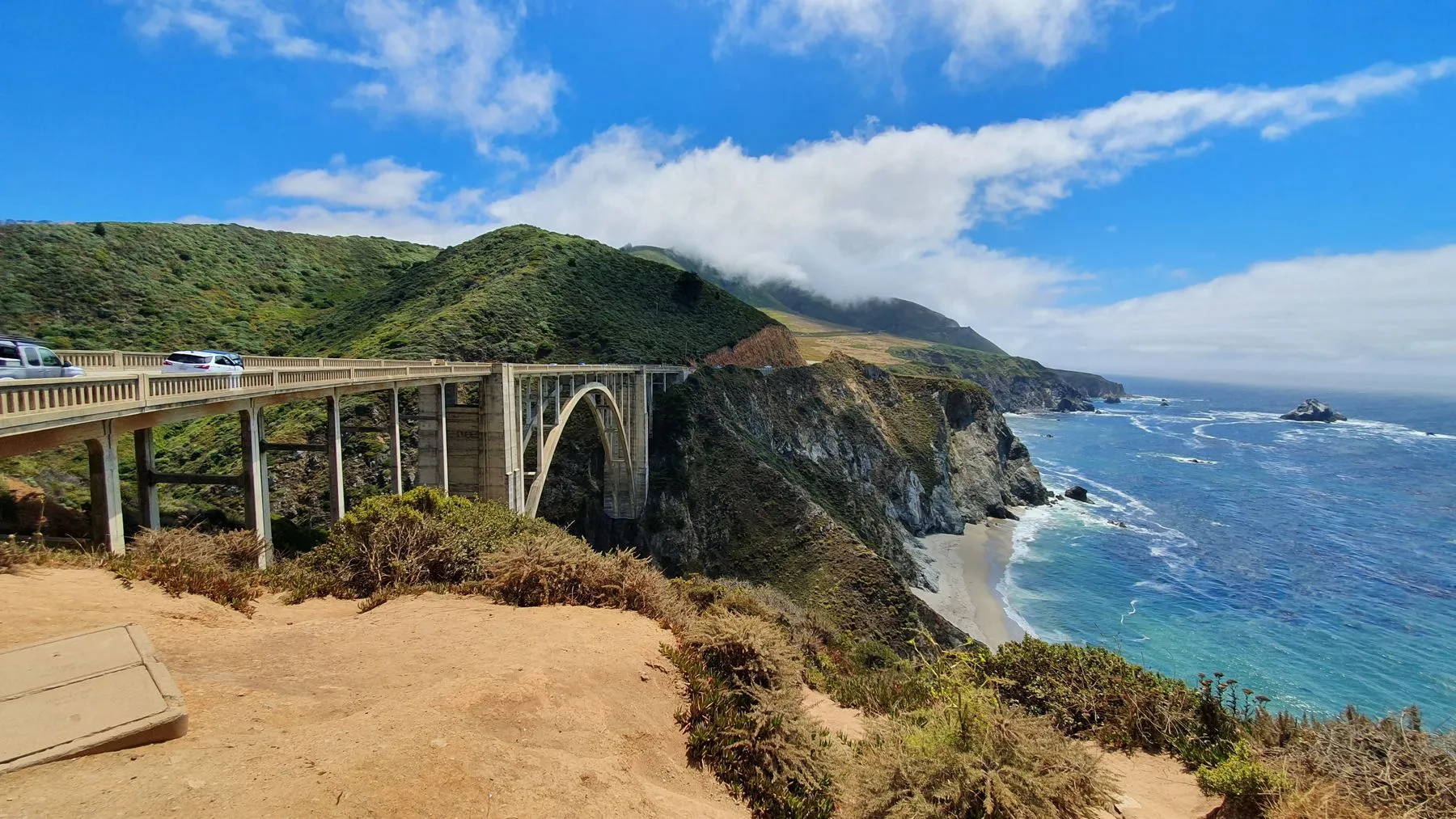 Bixby Creek Bridge on Highway 1 above the Big Sur coast, the halfway point of the Big Sur International Marathon, where a tuxedo-wearing pianist plays a grand piano.