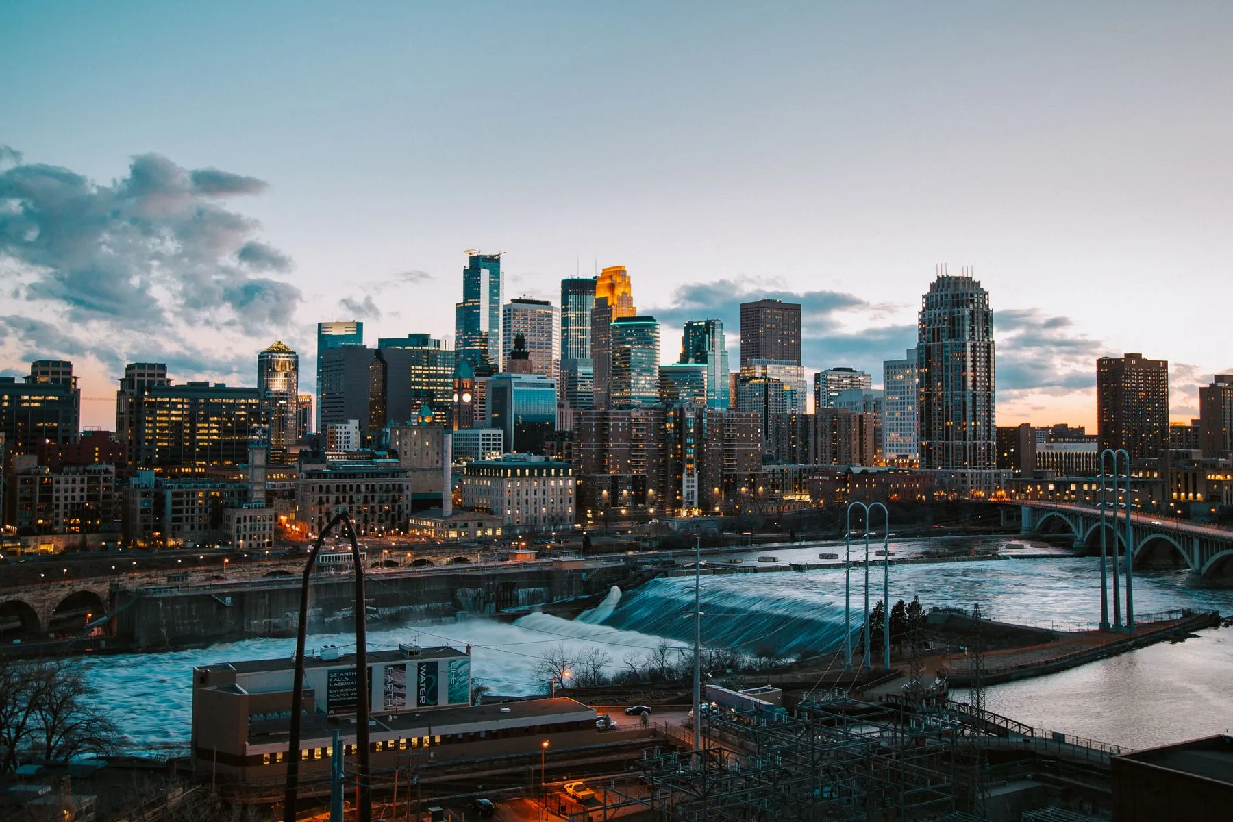 The Minneapolis skyline above the Mississippi River at sunset, the marathon starts downtown and crosses the river on its way to Saint Paul.