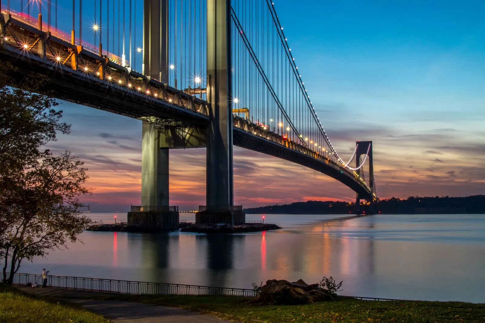 The Verrazzano-Narrows Bridge at twilight, connecting Staten Island to Brooklyn, the marathon starts at its Staten Island end and the bridge closes to traffic at 7am on race day.